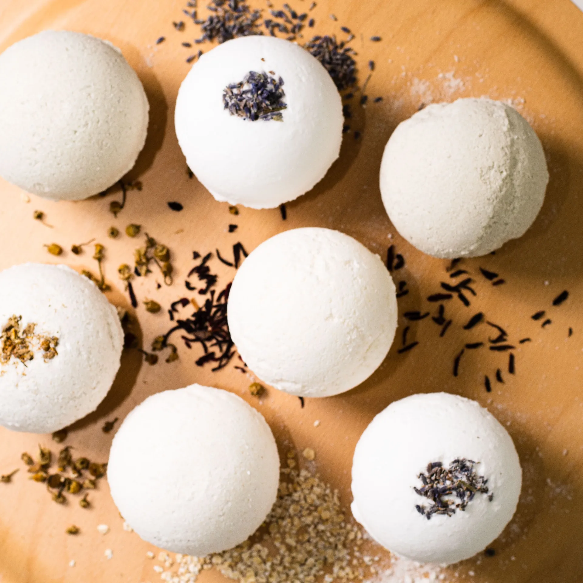 Bath bombs on golden tray with botanicals