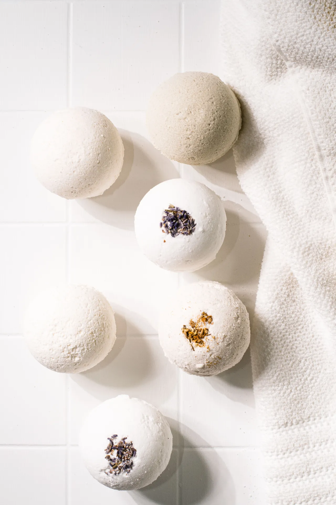Botanical bath bombs on white tile