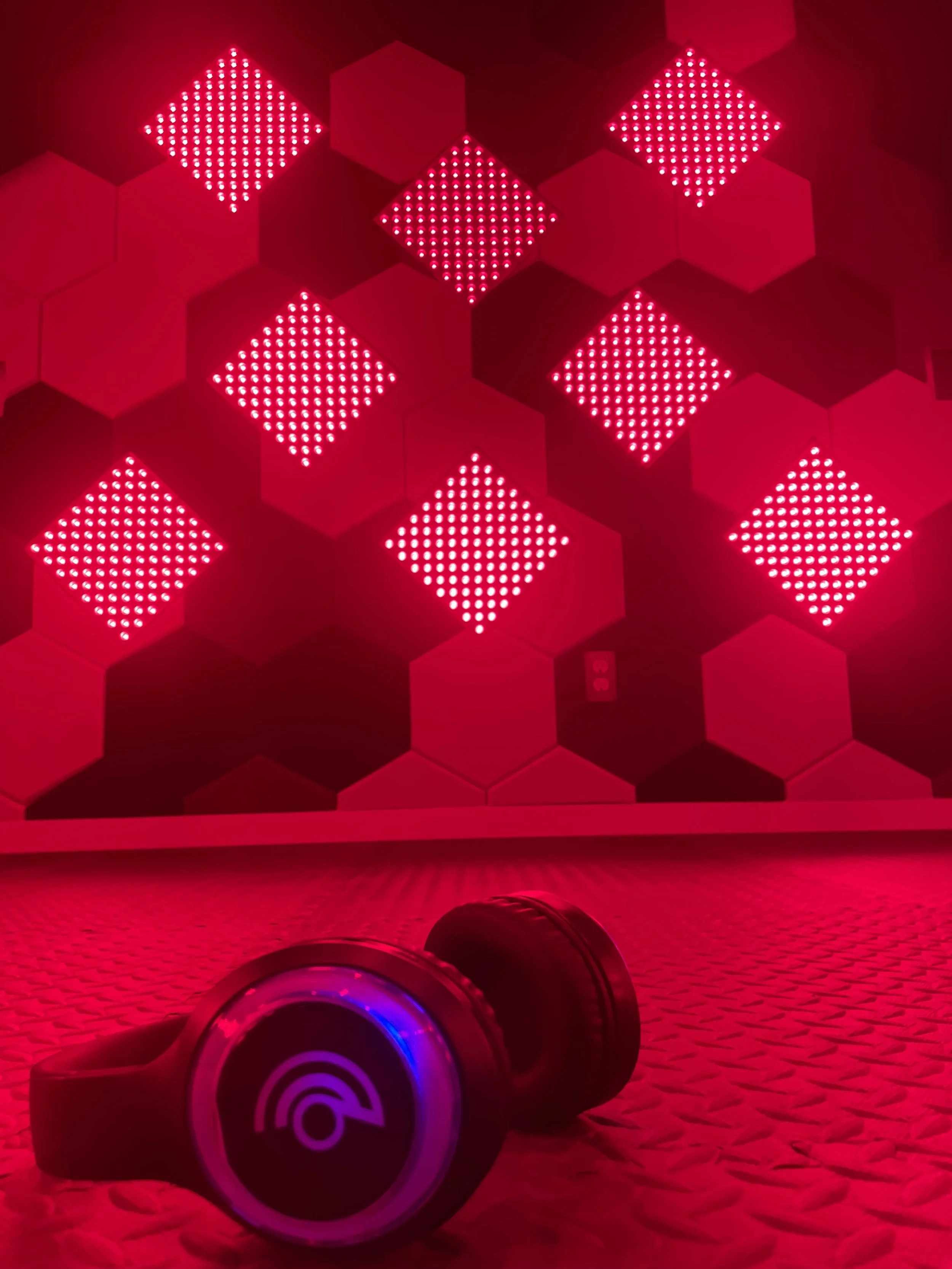 Red light room with sound-cancelling headphones